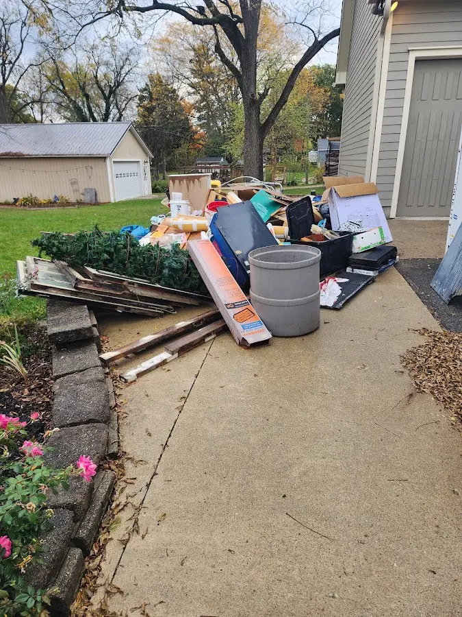 Dumpster being loaded with debris for Roofing Dumpster Rental in Longwood